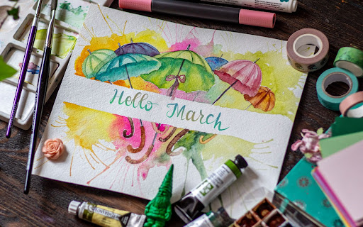 Art work with colorful umbrellas, craft supplies and says Hello March