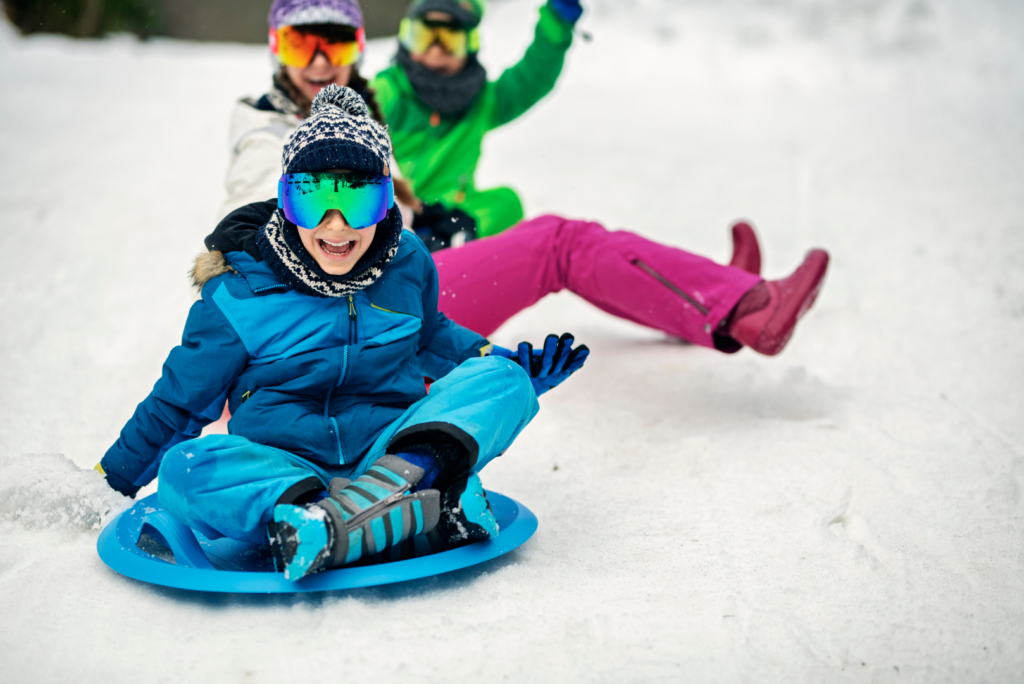 kids sledding in snow near wisconsin new home communities