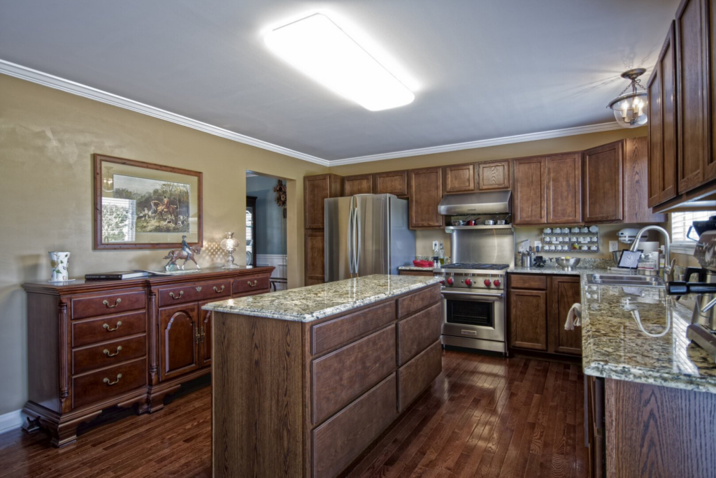 Gerstad Builders kitchen interior with wooden cabinetry and granite countertops