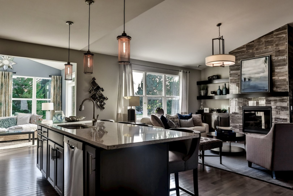 large kitchen island with dark cabinetry, pendant lighting