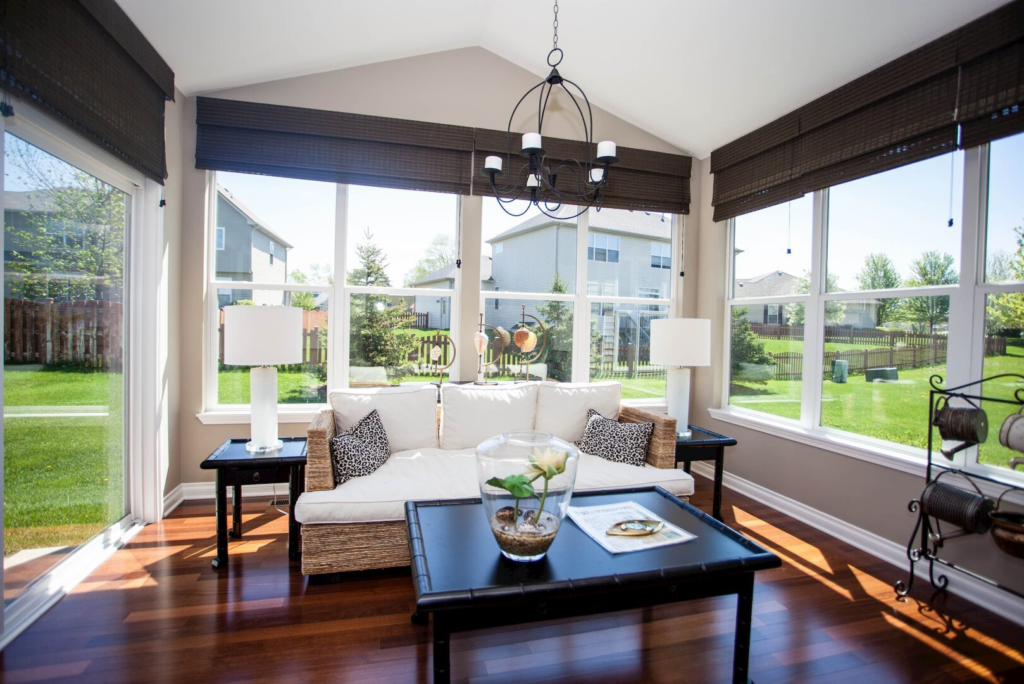 breakfast room with three walls of large windows, rich hardwood flooring and easy access to the backyard