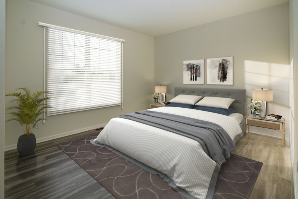 trendy bedroom with light beige walls and luxury vinyl plank flooring